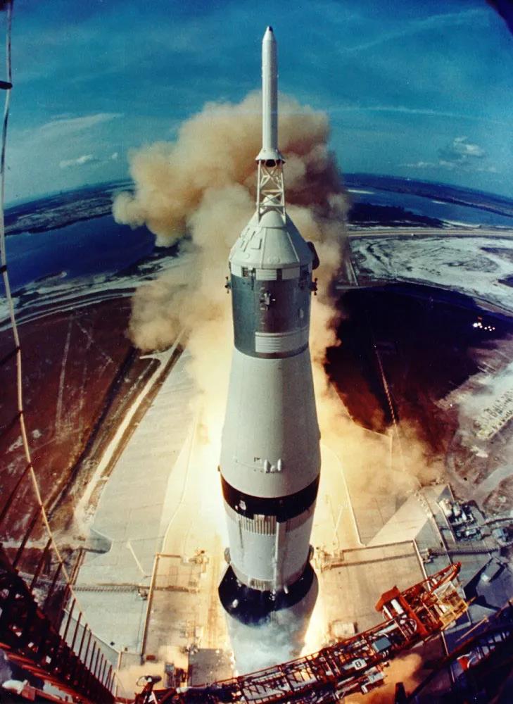 moke and flames signal the opening of a historic journey as the Saturn V clears the launch pad. Click image to enlarge.
